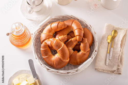 Golden and hot croissants with honey for breakfast.