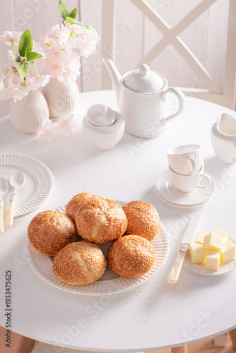 Sweet and homemade rolls with sesame seeds, butter and honey.