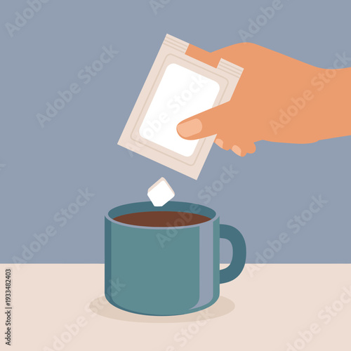 Hand holding tea bag over a blue mug on table indoors