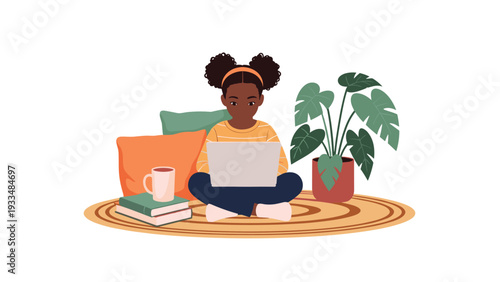 Young girl with space buns hairstyle sits cross-legged on a rug while focused on her laptop for online learning or creative projects.