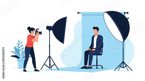 Professional female photographer takes a portrait of a man in a photo studio with large softbox lights and a backdrop.