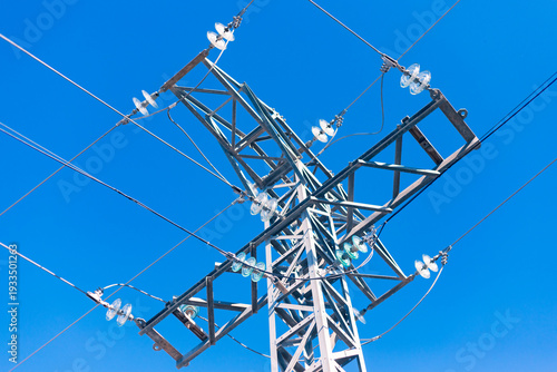 Cuadro en lienzo Electric Transmission Tower Viewed From Below Against Blue Sky