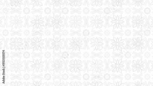 Close-up of white snowflake patterns on a white background with a shallow depth of field and delicate details.