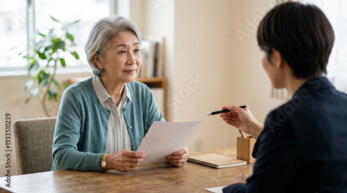 Wallpaper Mural Senior asian woman having a serious discussion with a consultant or advisor at home Torontodigital.ca