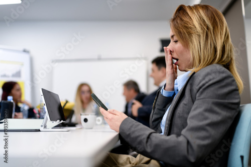 Cuadro en lienzo Business meeting with attendees showing interest and distraction in their device