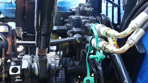 Double hydraulic joint.  Close up of pressure pipe of hydraulic system in agricultural machinery or other machinery with selective focus.