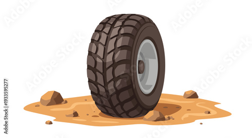 A rugged vehicle tire with aggressive tread stands upright on a patch of light brown dirt with scattered small rocks.