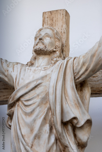 Statue of Jesus on the cross displayed in a quiet room during daylight