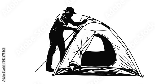 Silhouette of person setting up a camping tent outdoors