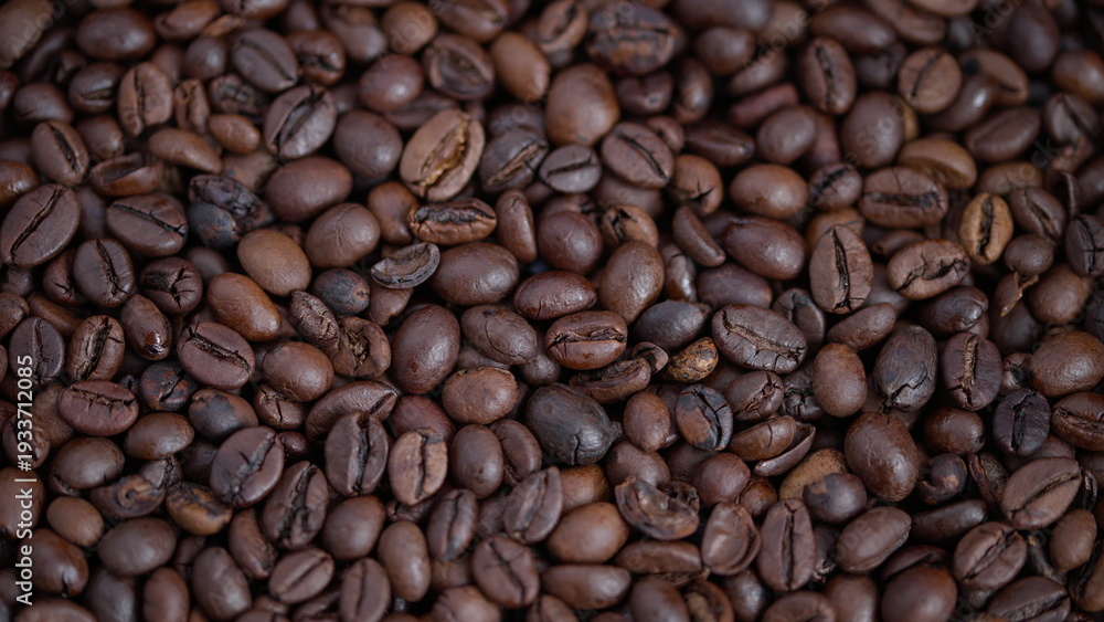 Fototapeta premium Closeup of glossy roasted beans with textured appearance and rich tones, Magnified image of shiny roasted coffee beans showing diversity in shapes and tactile surface features