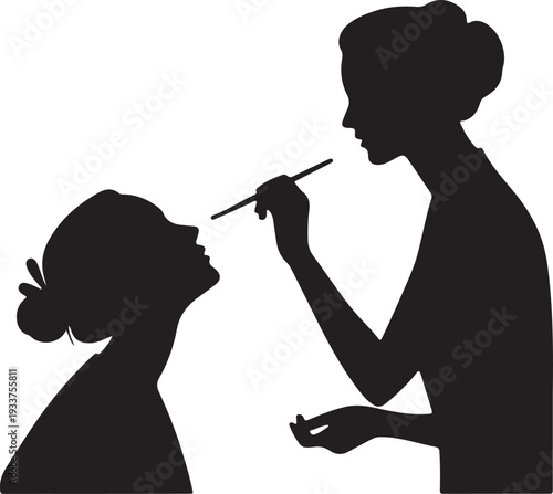 Makeup Artist Applying Cosmetics to a Woman's Face Silhouette