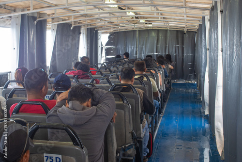Фотография Passengers Seated on the Open Upper Deck of a Ferry During a Sea Voyage