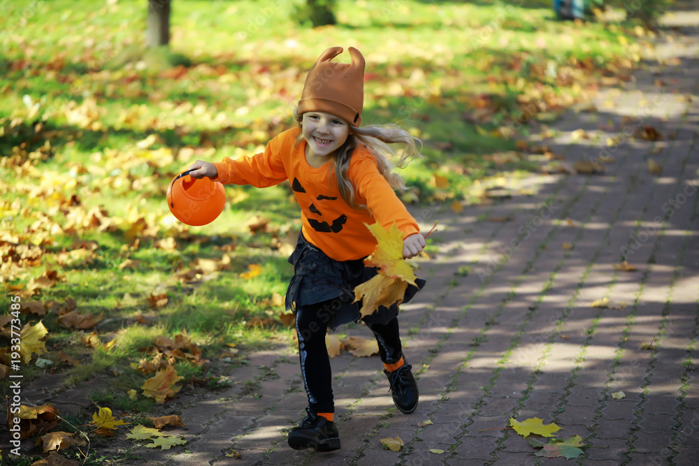 Fototapeta premium Happy family walk in the park on Halloween. Family dressed up in Halloween costumes