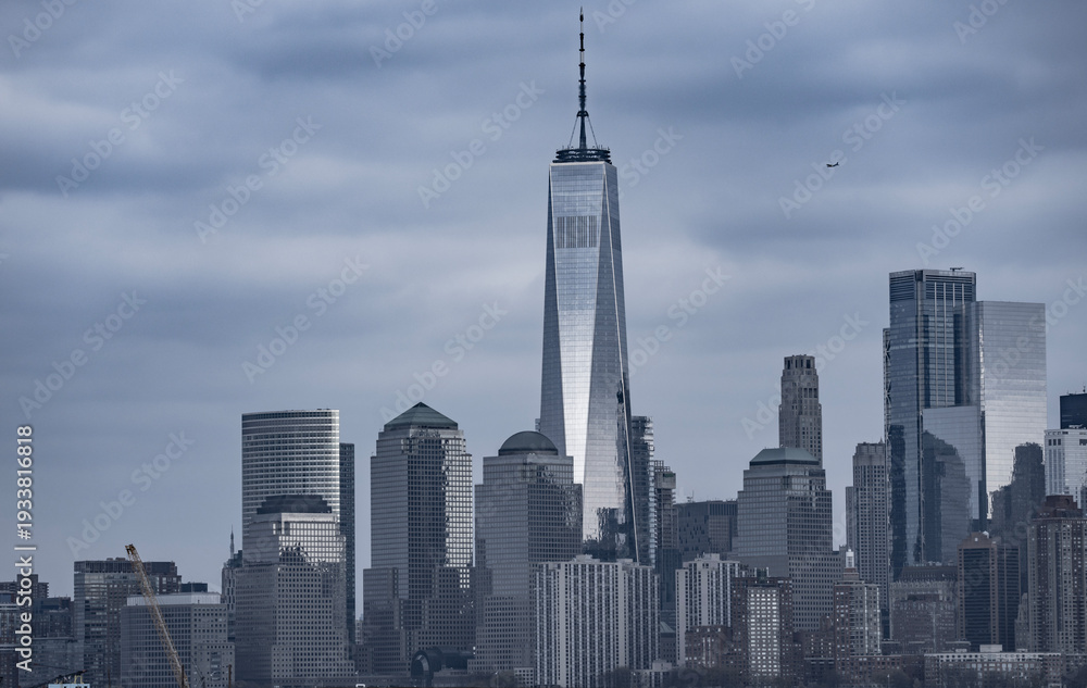 Obraz premium Manhattan cityscape over waterfront. NYC skyline scenic river view. New York City skyline iconic panorama. Manhattan skyline photography scene. NYC skyline modern American city.