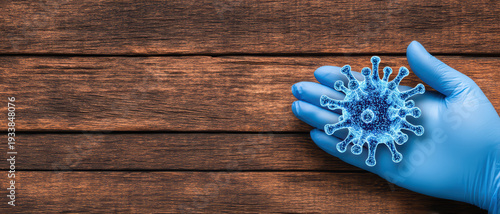Blue gloved hand holding 3D virus model on wooden background, symbolizing infection control and medical safety with realistic close up flat lay style