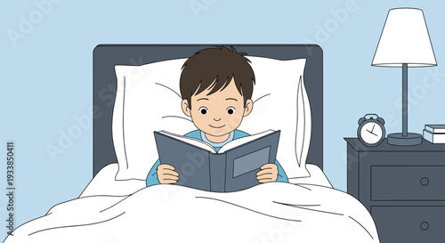 Young boy lying comfortably in his bed under a white blanket reads a storybook by the light of a bedside lamp.