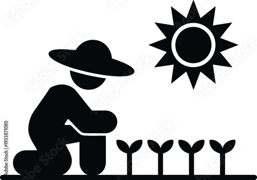 Gardener kneeling beside young plants under the warm sunlight nurturing growth and development in a serene outdoor setting with care.