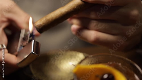 Elegant man lighting a cigar with a metallic lighter in a pub.