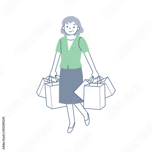 多数のショッピングバッグを持って歩くシニア女性