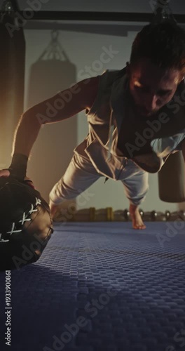 Athlete grips heavy ball with focused intensity