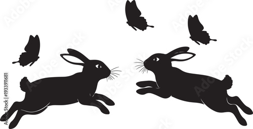 Two black rabbits and butterflies in flight together outside