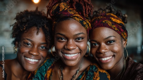 This vibrant image captures the joyful expressions of three friends who share a moment of happiness, showcasing their beautiful smiles and colorful headwraps perfectly.