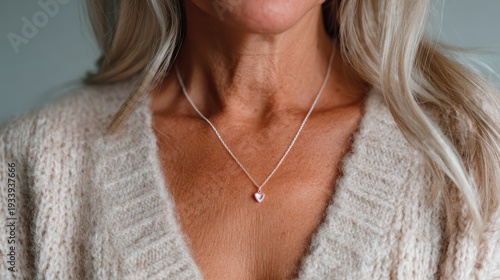 Wallpaper Mural A close-up shot of a graceful woman adorned with a delicate heart-shaped necklace, symbolizing love and elegance in a simple yet striking composition. Torontodigital.ca