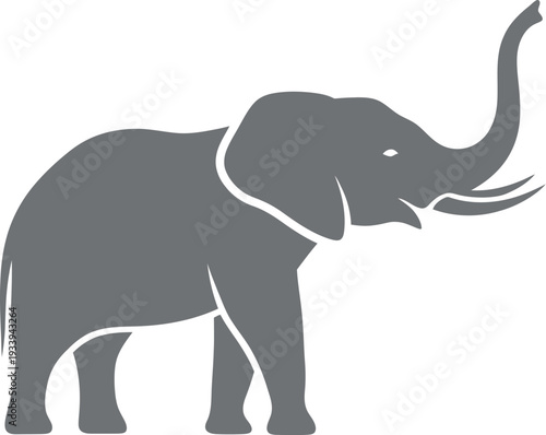 Elephant silhouette stands proudly with its trunk raised high in a.