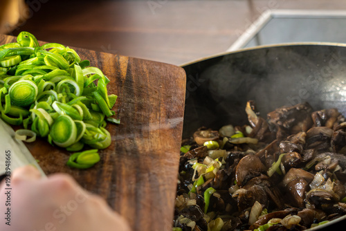 Adding sliced leek to sauteed mushrooms in skillet