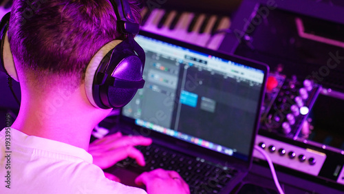 Tableau sur toile Young Producer Focuses Editing Track, Headphones On