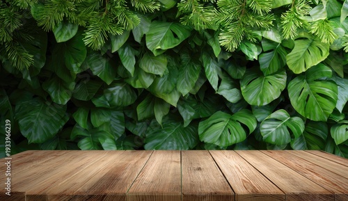Wooden table foreground with large green tropical leaves in background