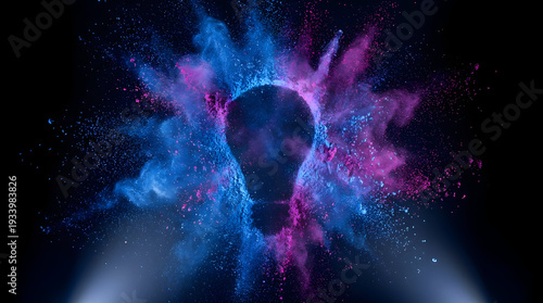 Abstract glowing light bulb silhouette made of colorful blue and purple smoke and particles illuminated by a bright spotlight on a dark black background
