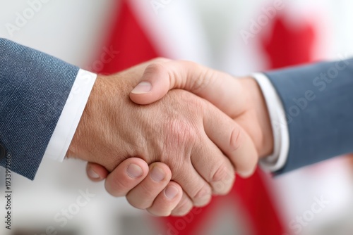 Close handshake signaling startup partnership with confident grip, smart suits, optimistic energy, blurred office banner, sense of investor founder alignment and future momentum
