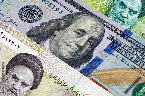 US Dollar and Iranian Rial Banknotes with portraits of Benjamin Franklin and Ruhollah Khomeini. War between the United States and Iran.