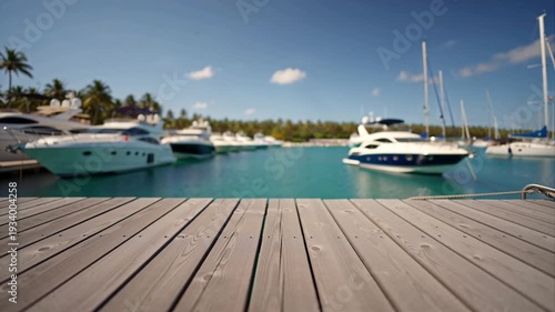 close-up of a wooden pier, with yachts and the sea in the background