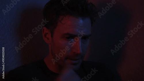 Entering a Quiet Room Under Blue and Red Lighting