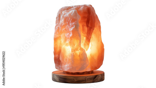 Himalayan salt lamp in warm orange glow on wooden base for home decor and wellness