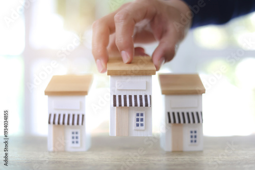 Hand chooses wooden franchise business store for franchising to growth branch expansion and business banking loan or consumer resources service.