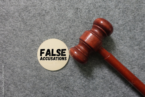 Фотография Gavel and false accusations symbol on courtroom background