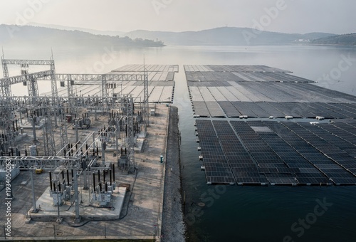 Aerial view of solar energy facilities integrated with electrical power substations showcasing innovative renewable energy solutions in a serene aquatic environment