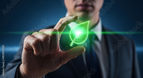 Businessman holding a glowing green leaf symbol, representing environmental sustainability and eco-friendly initiatives for a greener future