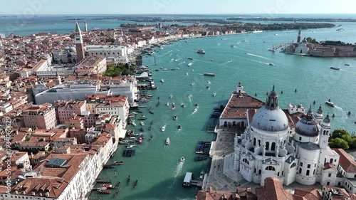 Drone shot over St. Mark's Basin with bustling boat traffic in Venice, Italy