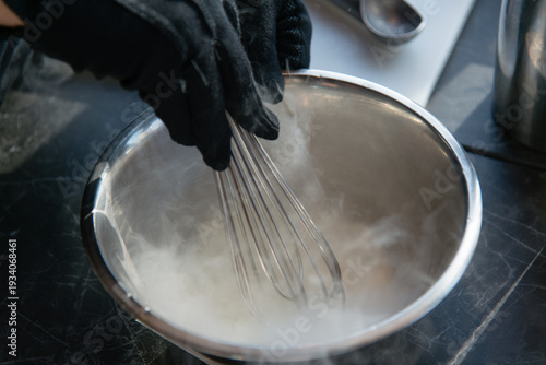 Cooking chef making ice cream added liquid nitrogen, process of making ice cream dessert	