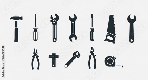 Collection of various black hand tools on a white background for diy projects and repairs
