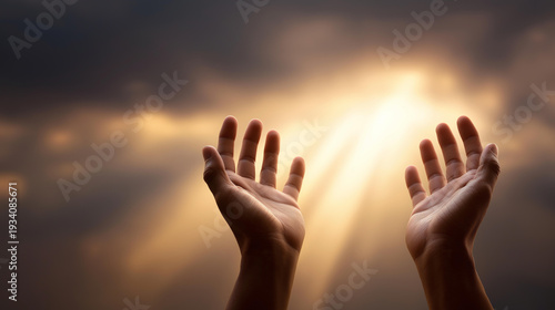 Two faceless hands reaching upward toward a single ray of golden sunlight breaking through stormy clouds, defocused blurred sky background, hope, faith, prayer, surrender, spiritual yearning,