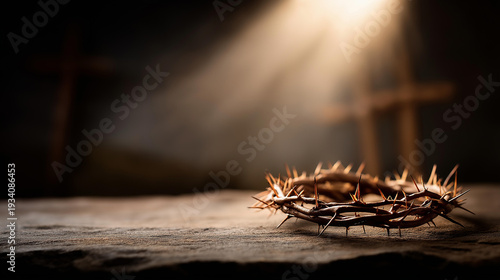 Detailed crown of thorns resting in a shaft of dramatic spotlight on dark stone, defocused wooden crosses on a distant hill at sunset, Passion Week, sacrifice, Good Friday, Easter, Christian