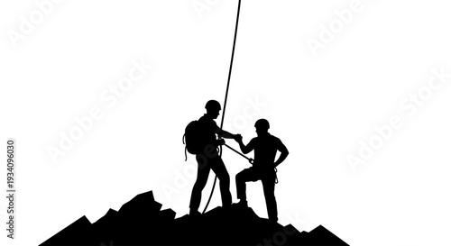 Two climbers standing on mountain peak with ropes secured