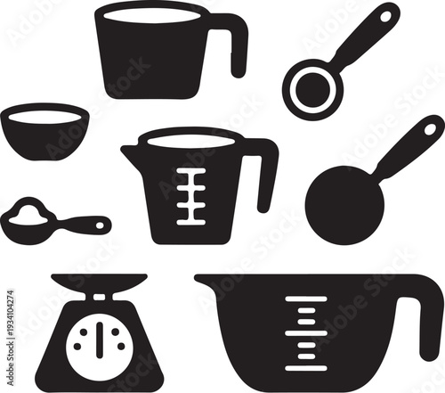 Black kitchen utensils and measuring cups on white background
