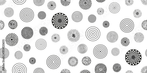 Abstract arrangement of varying circles and spiral patterns in grayscale