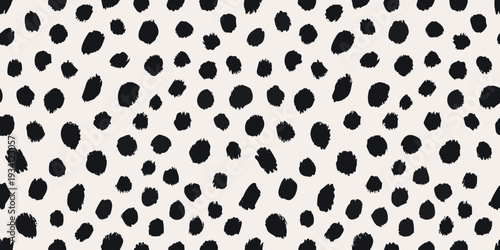 A seamless pattern of irregular black spots on a cream background